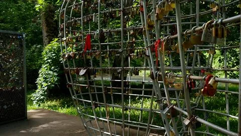 Love padlocks on metal structure representing commitment and romance Stock Photos