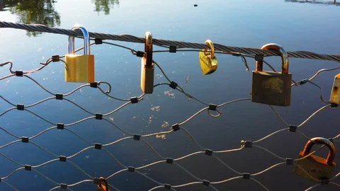 Love padlocks on railing of bridge with water in background in Holland Video stock 106936066