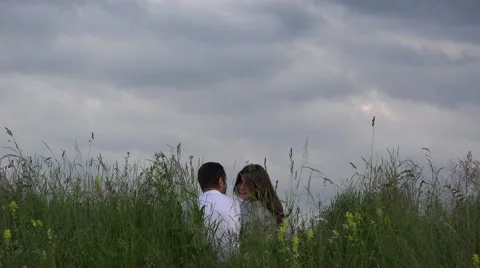 Love scenery, spring meadow, dramatic sky,attractive woman smiling close man  Video stock 46206940
