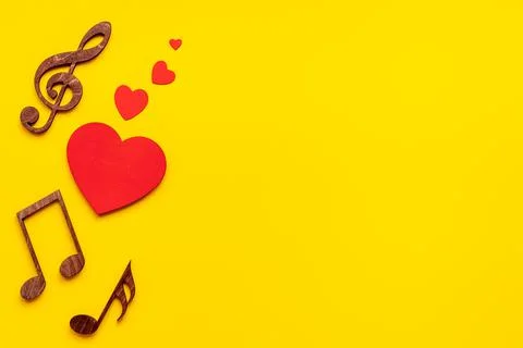 Love songs - musical wooden notes with heart, top view Stock Photos