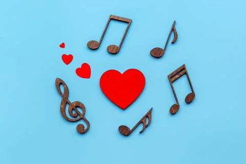 Love songs - musical wooden notes with heart, top view Stock Photos