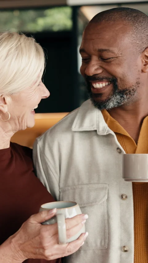 Love, support or interracial couple in house with coffee, partner care or Stock Footage 338112345
