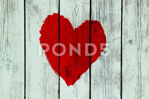 Love symbol on old wooden wall Stock Photos