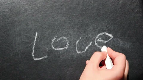 Love - womans hand write text with chalk on blackboard Stock Footage 94039792