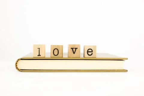 Love wording stack on a book Stock Photos
