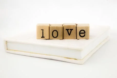 Love wording stack on a book Stock Photos