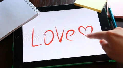 Love. Written on white background on tablet. Stockbeeldmateriaal 63139459