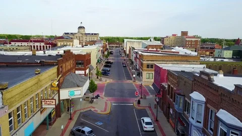 A lovely aerial over a Main Street in small town USA ends with two kids Stock Footage