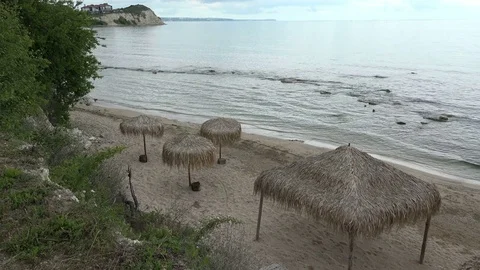 Lovely beach at sunset time with thatched umbrella  and pavilion for relax 動画素材 77873718