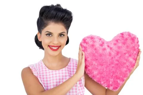 Lovely black hair model holding a pink heart shaped pillow Stock Photos