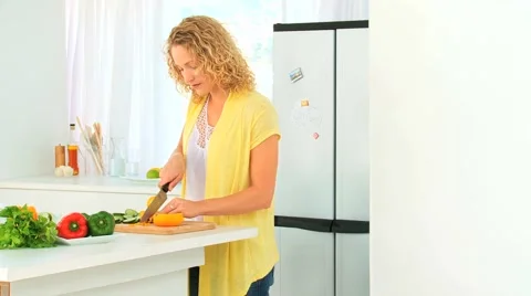 Lovely blond woman cooking Stock Footage