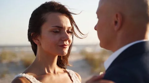 Lovely bride looking at groom at romantic photoshoot after wedding ceremony Stock Footage 252425193
