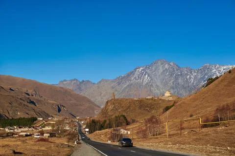 Lovely brown mountain tops against the backdrop of a clear blue sky evoke a Stock Photos