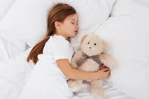 Lovely child sleeping with a teddy bear Stock Photos
