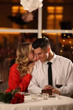 Lovely couple having romantic dinner on Valentine's day in restaurant Stock Photos