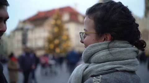 Lovely couple kissing in front of Christmas tree in Prague Old Town Stock Footage