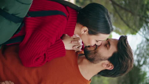 Lovely couple standing forest path vertical close up. Woman kissing bearded man Stock Footage 261221340
