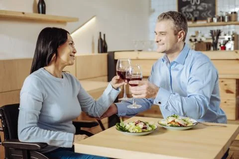 Lovely couple talking while drinking wine Stock Photos