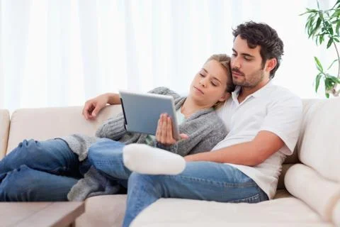 Lovely couple using a tablet computer Stock Photos
