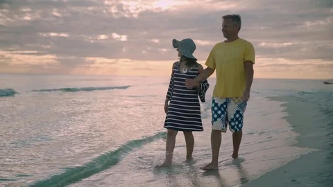 Lovely couple walking under the moonlight on the beach Stock-Footage 74909347