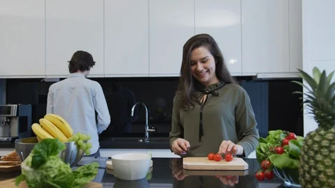 Lovely couple working in the kitchen Stock Footage 99941649