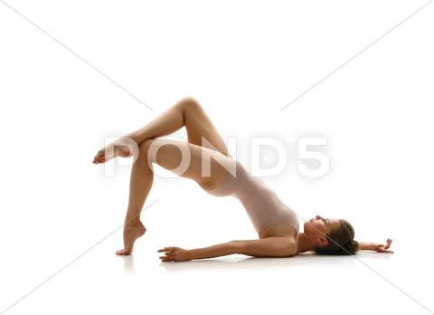 Lovely gymnast posing in studio. Isolated on white Stock Photos