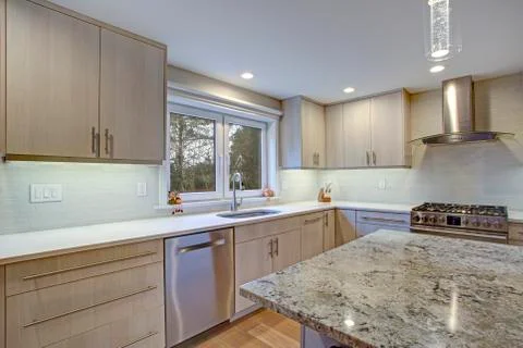Lovely kitchen room interior features ivory cabinets accented with lucite pul Stock Photos