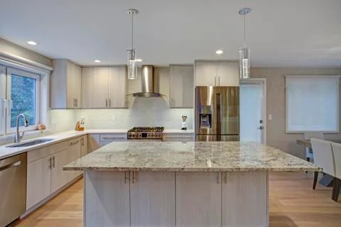 Lovely kitchen room interior features ivory cabinets accented with lucite pul Stock Photos