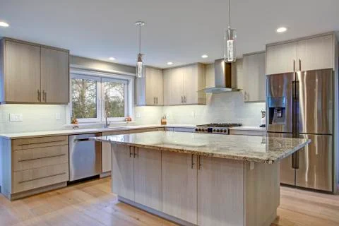 Lovely kitchen room interior features ivory cabinets accented with lucite pul Stock Photos