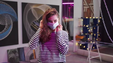 A lovely painter is putting on a mask Stock Footage 155245973