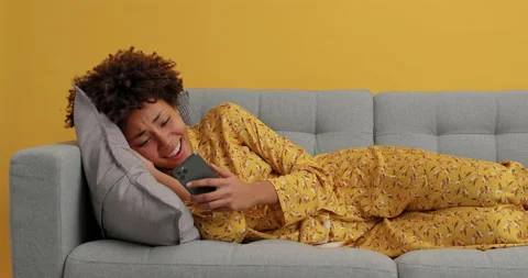 Lovely pleased dark skinned young woman browses wireless internet on modern Stock Footage 144050341