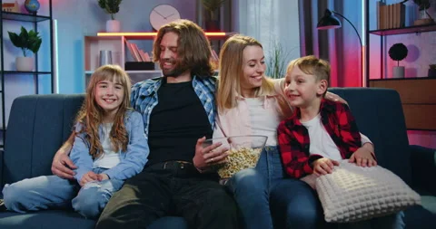 Lovely smiling happy friendly modern family sitting together on the comfortable Stock Footage 158024642