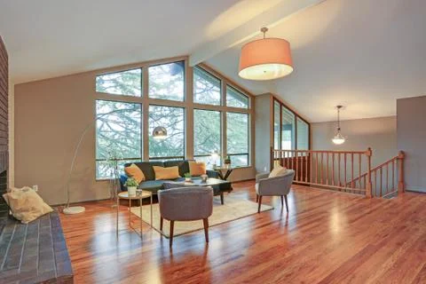 Lovely spacious open floor plan with vaulted ceiling and tan walls features l Stock Photos