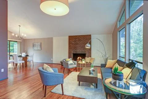 Lovely spacious open floor plan with vaulted ceiling and tan walls features l Stock Photos
