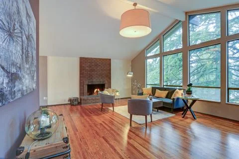 Lovely spacious open floor plan with vaulted ceiling and tan walls features l Stock Photos