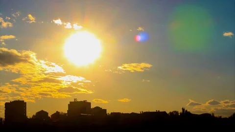 Lovely Time Lapse of sunset, with big golden sun, with golden clouds, with lense Stock Footage 83632228