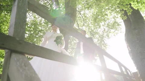 Lovely wedding couple in the forest. The bride kisses the groom. Slow motion Stock Footage 234086480