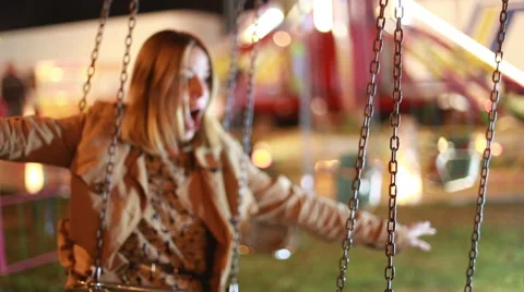 Lovely woman on swing in amusement park Stock Footage 59556283