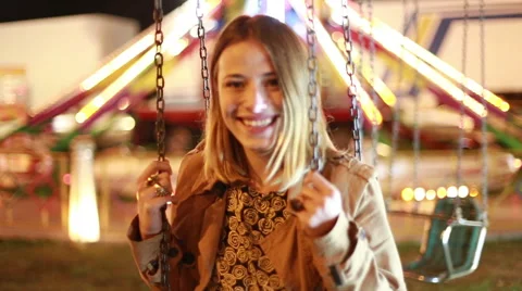 Lovely woman on swing in amusement park Stock Footage 59556284