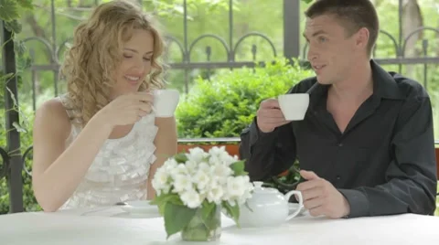 Lovely young couple considering menu outdoors in summer cafe Stock-Footage 7766843