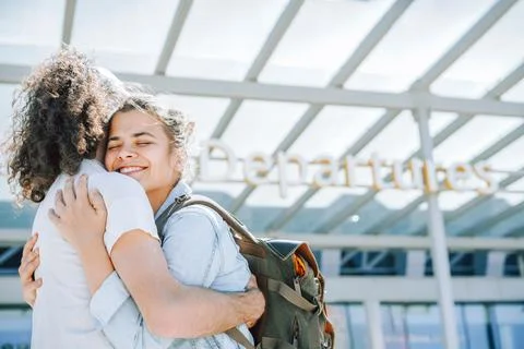 Lovely young couple hugging at the airport departures Stock Photos
