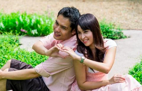 Lover couples sit in the garden 写真素材
