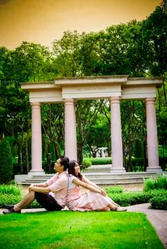 Lover couples sit in the garden Stock Photos