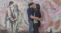 lover kissing in graffiti behind a couple kissing - love - hug HD Footage