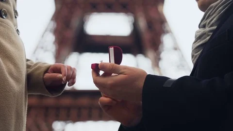 Lover making marriage proposal to his beloved girl on background of Eiffel Tower Stock Footage 83900612