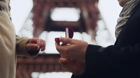 Lover making marriage proposal to his beloved girl on background of Eiffel Tower Stock Footage 83904052