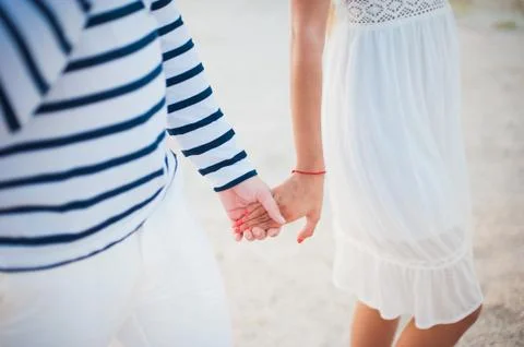 Lovers on the beach. Hand in Stock Photos