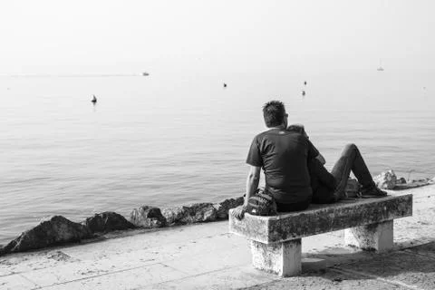 Lovers on the bench in front of the lake 库存照片