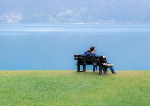 Lovers on a bench on the lake Stock Photos