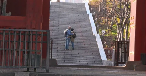 Lovers climbing the stairs of the shrine while taking a photo in japan Stock Footage 122096027